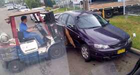 workers moved parked car forklift 1